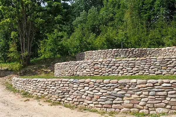 Terraced rounded-stone retaining walls holding a garden slope